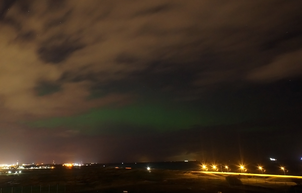 A brief glimpse of Aurora between the clouds